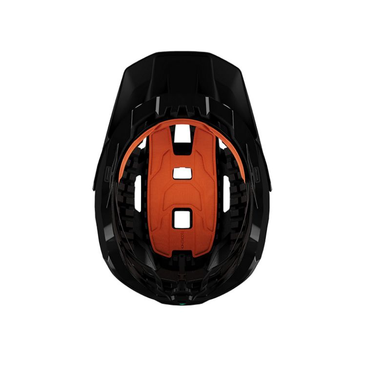 Interior view of a matte black mountain bike helmet highlighting orange impact-protection padding, integrated ventilation channels, internal cage structure, and adjustable fit system, displayed on a light grey background.