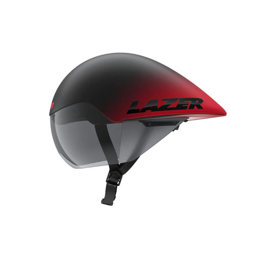 Side view of an aerodynamic cycling time-trial helmet with a matte black-to-red gradient finish. The helmet has an elongated teardrop-shaped rear profile, an integrated tinted visor, and a black chin strap with buckle. The brand name “LAZER” is displayed in large black lettering on the red side panel. Shown against a light gray background.