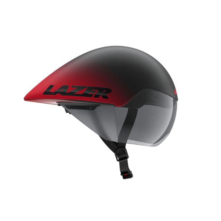 Side view of an aerodynamic cycling time-trial helmet with a matte black-to-red gradient finish. The helmet has an elongated teardrop-shaped rear profile, an integrated tinted visor, and a black chin strap with buckle. The brand name “LAZER” is displayed in large black lettering on the red side panel. Shown against a light gray background.