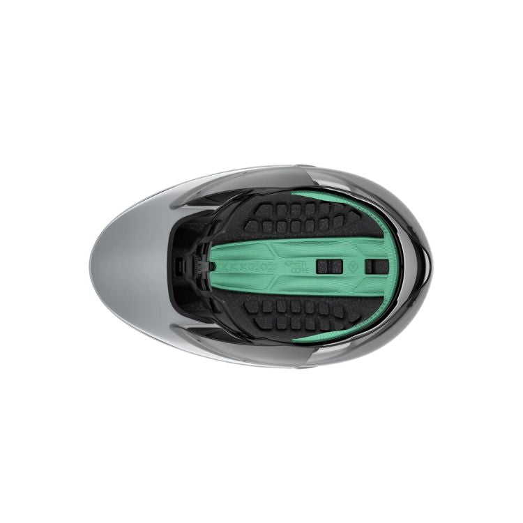 Top view of an aerodynamic cycling time-trial helmet with a smooth, elongated teardrop-shaped profile. The helmet has a matte white and silver finish with subtle ventilation openings near the front. The streamlined shell is displayed against a light gray background, highlighting its aerodynamic design.