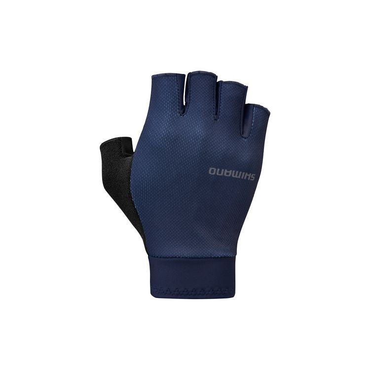 Navy blue fingerless cycling glove shown from the backhand side, featuring a breathable textured fabric upper, black thumb-side panel, and matching navy cuff. The glove has short finger openings with reinforced edges and a subtle gray Shimano logo printed on the back. Displayed against a light gray background.