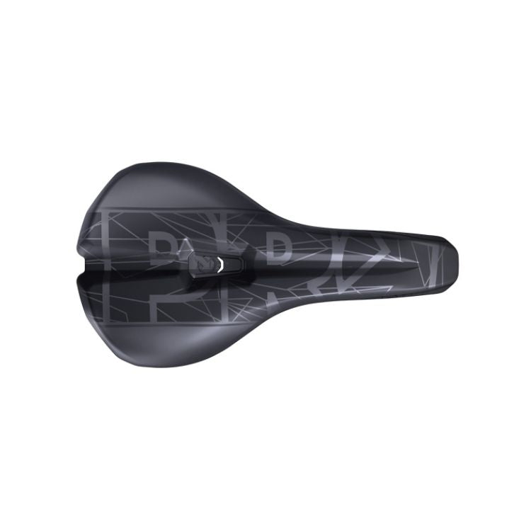 Top view of a black bicycle saddle with a wide rear platform, narrow nose, and central pressure-relief channel. The saddle surface features a dark gray geometric line pattern and large stylized letters across the top. The saddle is isolated on a light gray background.
