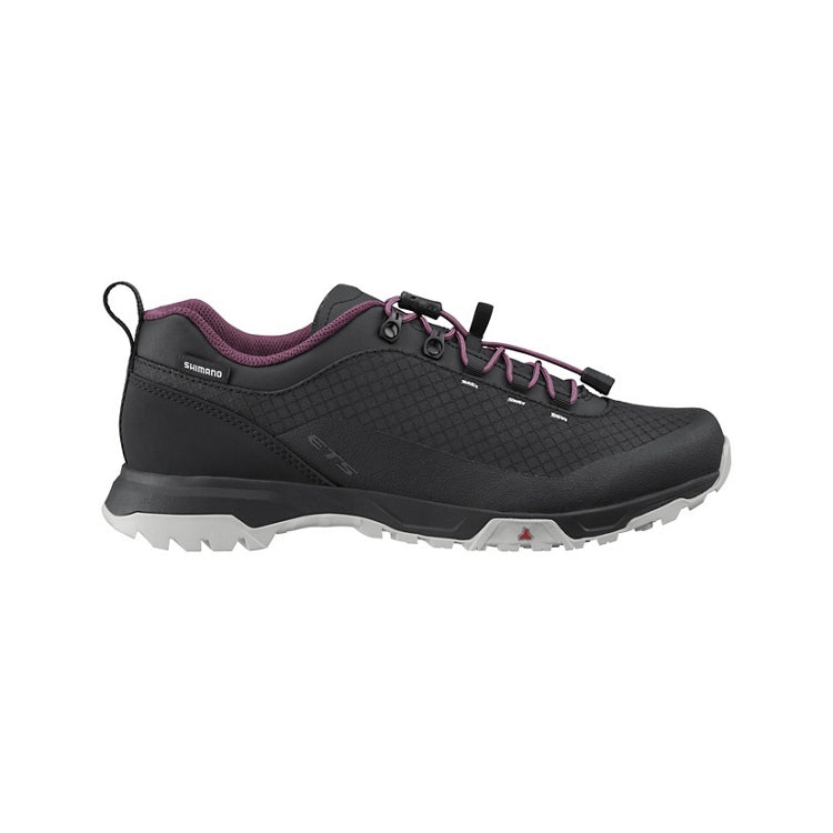 Black cycling shoe with purple accents and laces, black and white rubber soles, right view