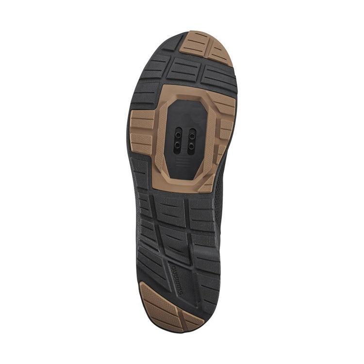 Close up of black and tan rubber soles, SPD, bottom view