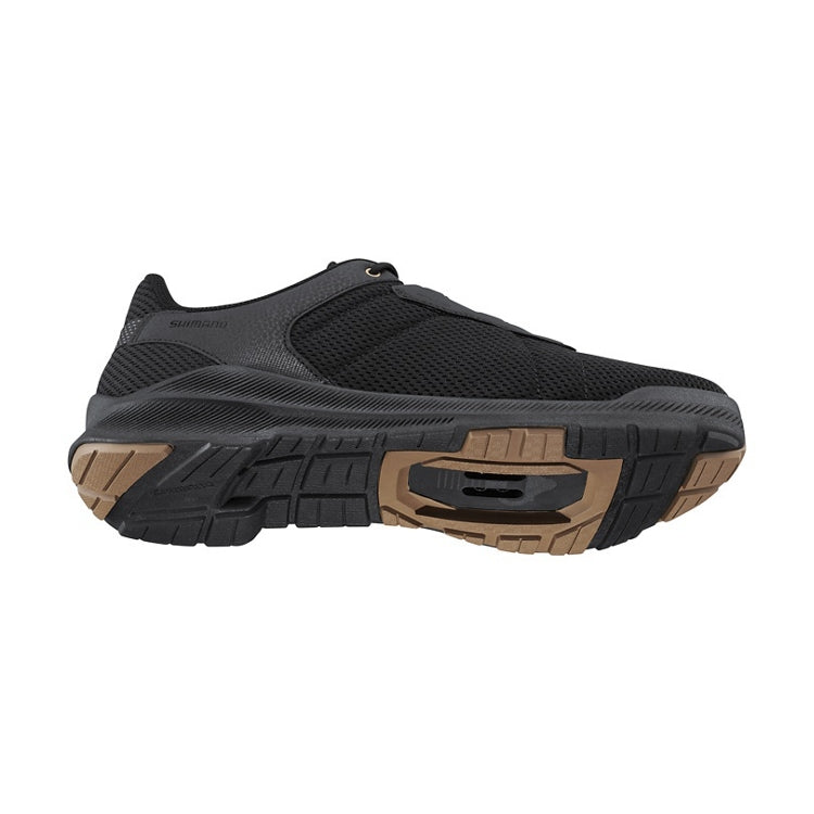 Black cycling shoe, black laces, Shimano logo, black and tan rubber sole, bottom view