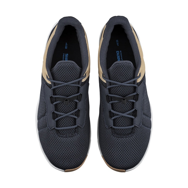 A pair of navy cycling shoe with beige accents, navy laces, top view