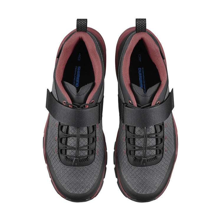 A pair of black and red shoes with black straps, top view