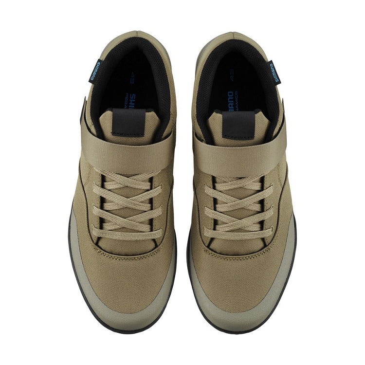 A pair of sand beige cycling shoes with strap and laces, top view