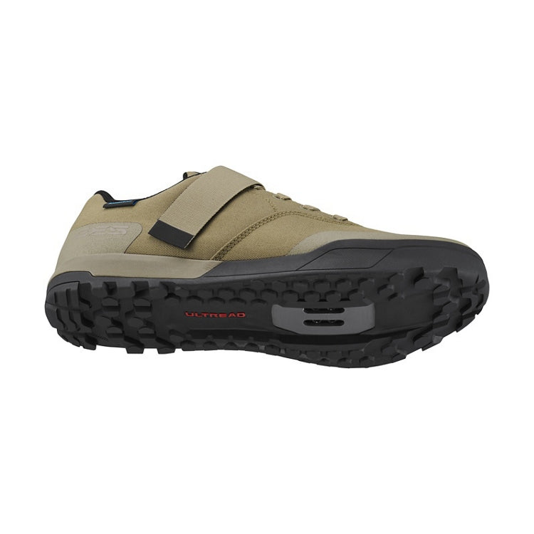 Sand beige cycling shoe with strap and lace, black and earth coloured rubber sole, 'Ultread' branding, bottom view
