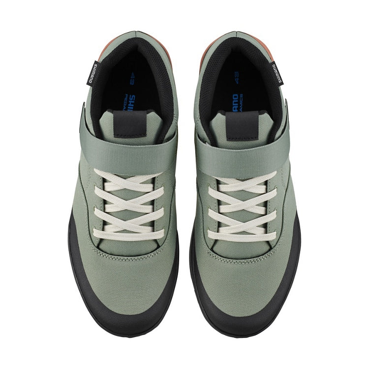 A pair of light green cycling shoe with light green strap and laces, top view