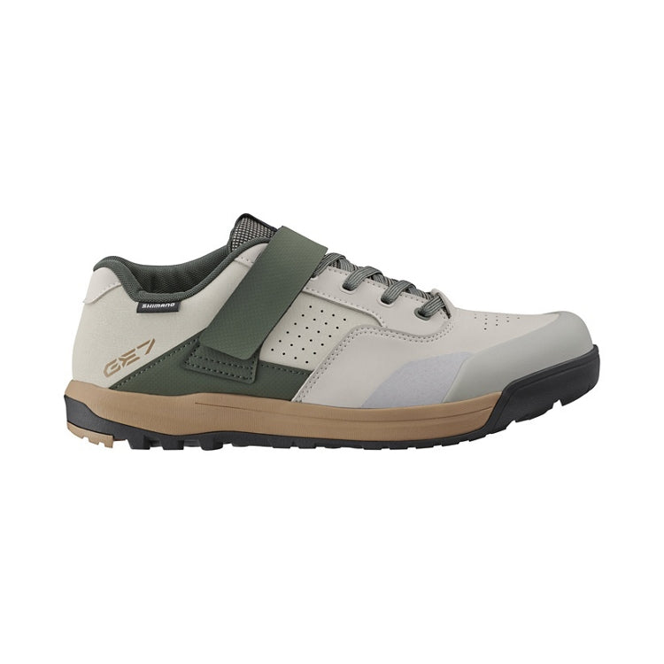Light gray shoe with green and beige design, tan and black rubber sole, right view