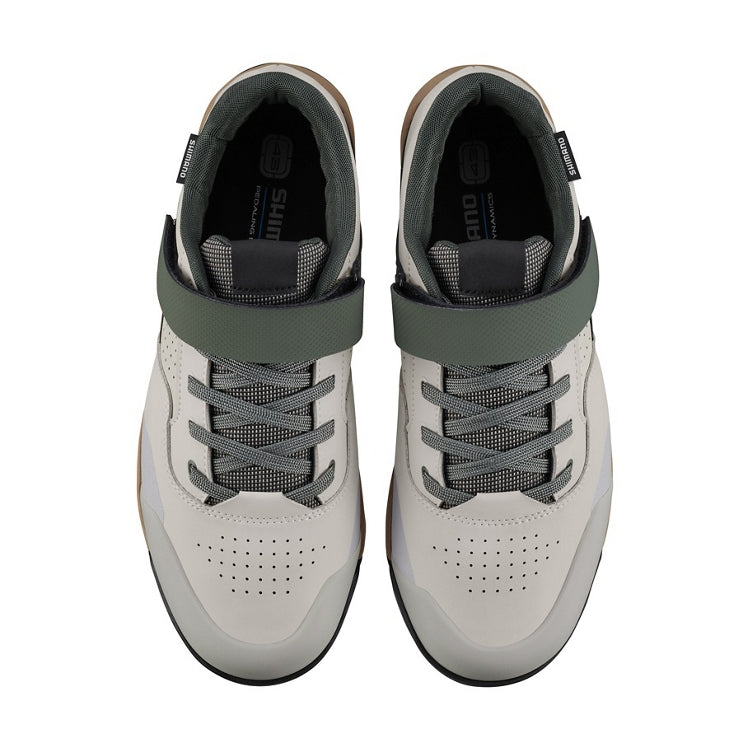 A pair of light gray shoe with green and beige design, top view