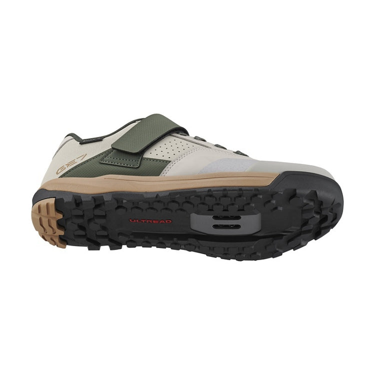 Light gray shoe with green and beige design, tan and black rubber sole, 'ultread' branding, bottom view