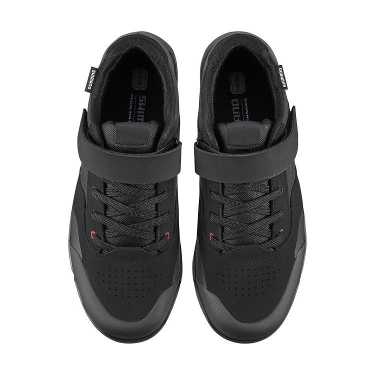 A pair of black shoe with black strap and lace, top view