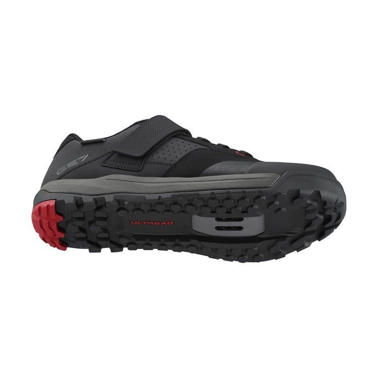 Black shoe with black strap and lace, black and red rubber sole, 'Ultread' branding on sole, bottom view