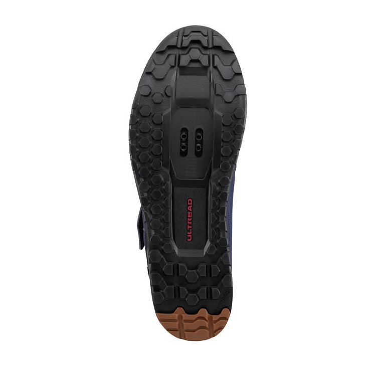 Close up of black and tan tipped rubber sole with SPD cleat and 'Ultread' branding, bottom view