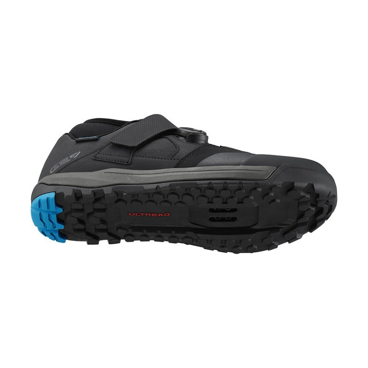 Black shoe with blue and black sole, one black BOA dial and black strap, 'ultread' rubber sole, bottom view