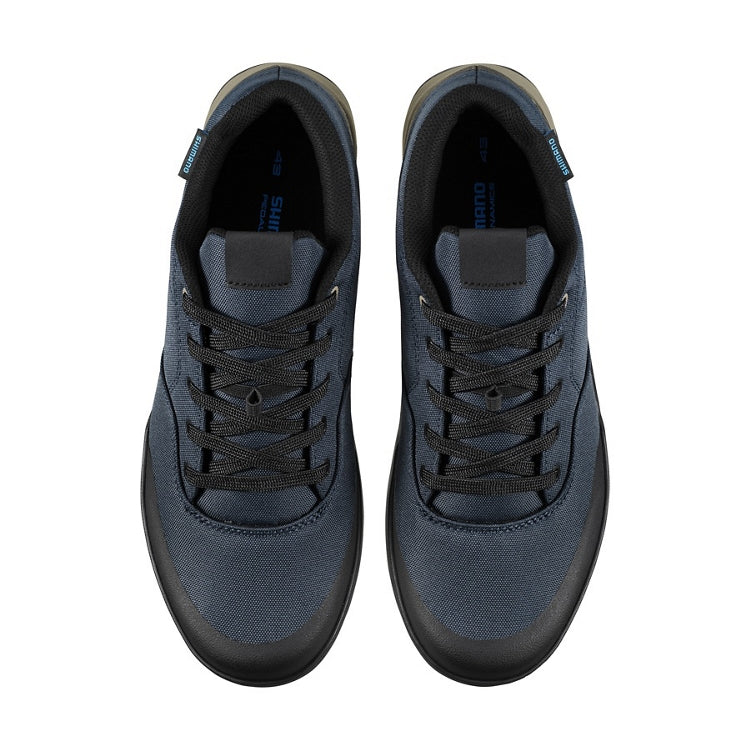 A pair of dark blue shoes with black laces, top view