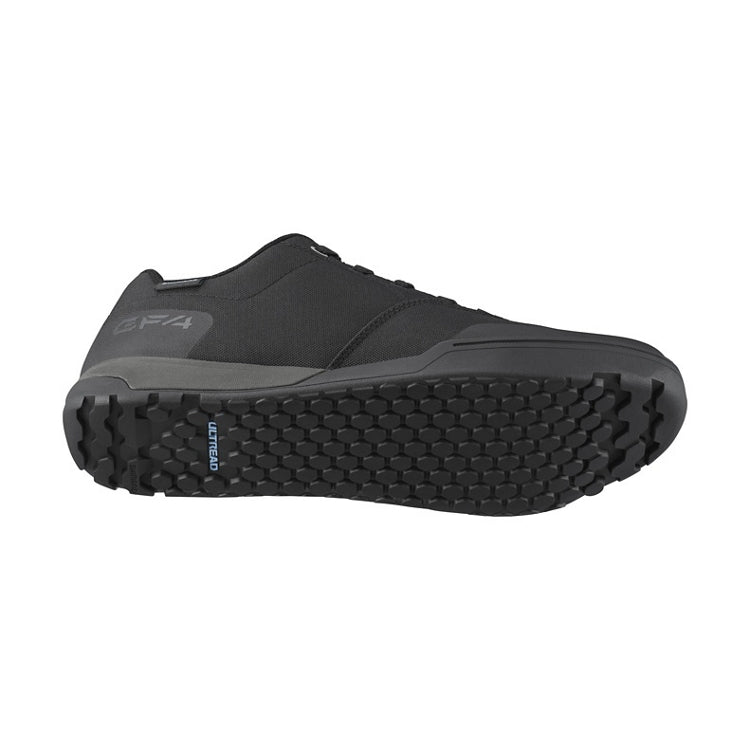 Black shoes with black laces, black sole, 'Ultread' branding on sole, bottom view
