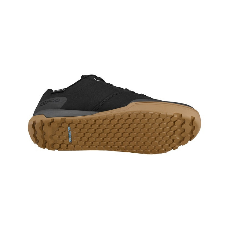 Black shoes with black laces, tan sole, 'Ultread' branding, bottom view