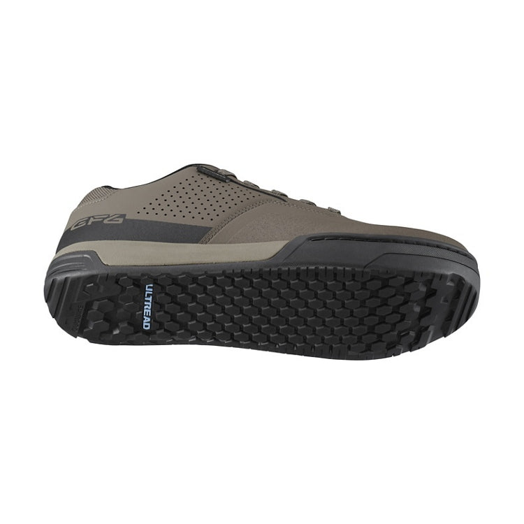 Brown shoe with green and black sole with laces, 'ultread' branding on sole, bottom view