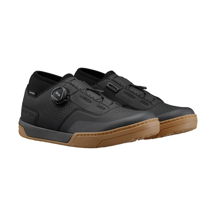 A pair of black cycling shoe with tan sole and black BOA dial, right view