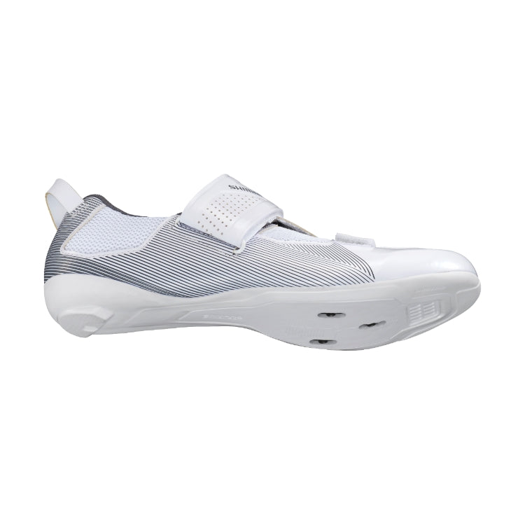 White cycling shoe with black stripes with Shimano logo on strap, bottom view