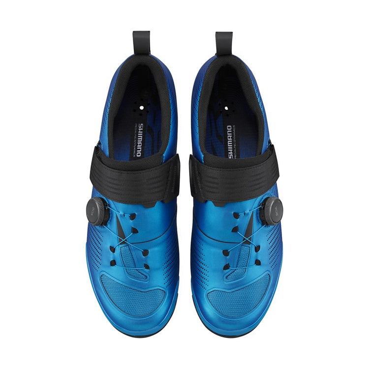 A pair of Shimano blue cycling shoe with black strap and black BOA dial, top view