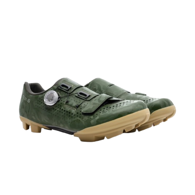 A pair of green cycling shoe with tan rubber sole and clear BOA dial, right view