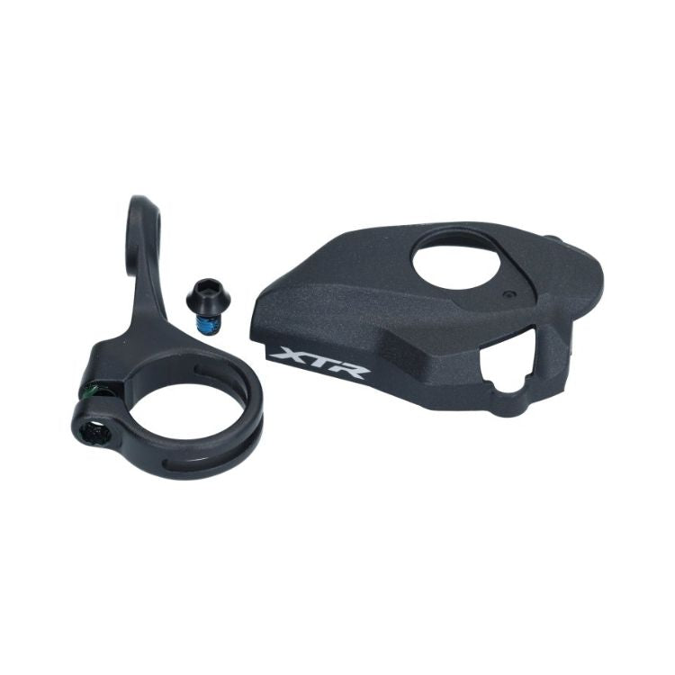 Shimano XTR bicycle shifter mount kit components, including a black handlebar clamp, mounting screw, and XTR-branded cover plate, displayed against a light gray background.