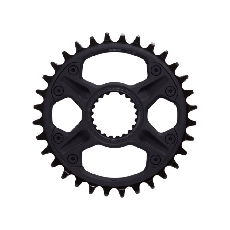 Black Shimano direct-mount bicycle chainring with 32 narrow-wide teeth, six recessed fastening bolts, and a splined center interface, shown against a light gray background.