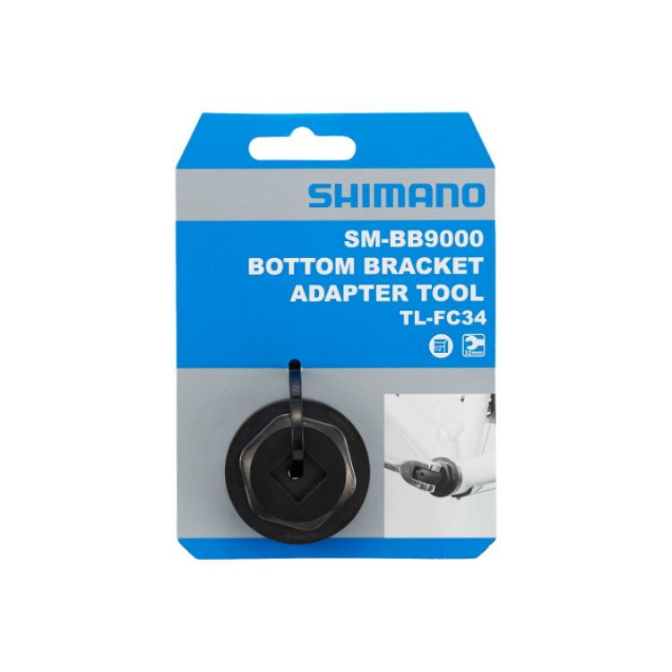 Front view of Shimano SM-BB9000 Bottom Bracket Adapter Tool TL-FC34 retail packaging in blue and white, displaying the tool through a clear blister pack with a product application image on the front.