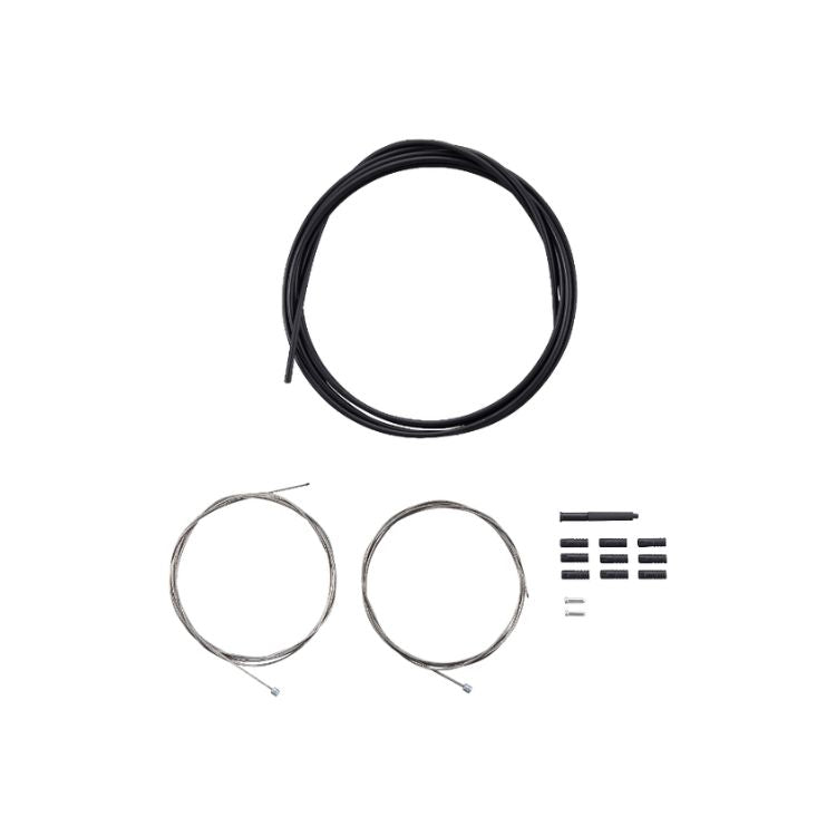 Shimano MTB shift cable set components arranged on a light gray background, including black shift cable housing, two stainless steel inner shift cables, housing ferrules, cable end caps, and small installation accessories.