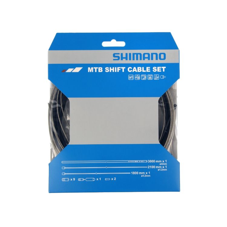 Front view of Shimano MTB Shift Cable Set retail packaging in blue and white, showing shift cable components inside a clear plastic pack, with cable lengths and included parts listed on the front.