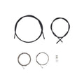 Shimano road brake cable set components arranged on a light gray background, including front and rear black brake cable housings, two stainless steel inner brake cables, cable end caps, and cable end crimps.