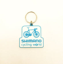 Load image into Gallery viewer, Shimano Cycling World Keychain
